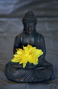 buddha statue with yellow flower for meditation and relaxation